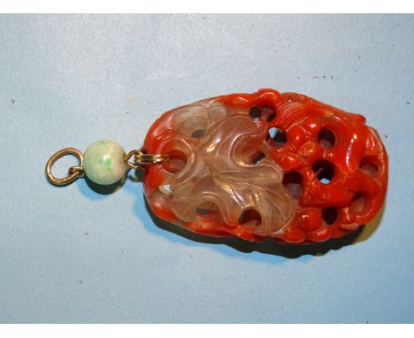 A Chinese red agate and rock crystal pendant carved in the form of leaves, berries and small animals, with yellow metal mount