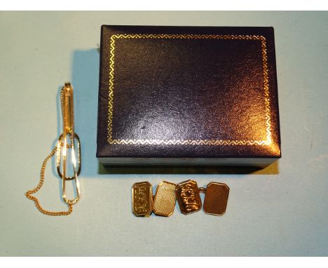 A pair of 9ct gold engine-turned cufflinks, (with engraved initials), 9.8g, (boxed) and a gold-plated tie pin. 