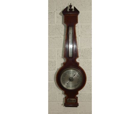 An Edwardian crossbanded mahogany aneroid barometer and thermometer, the silvered dial marked Owen & Robinson Ltd, Leeds, 100