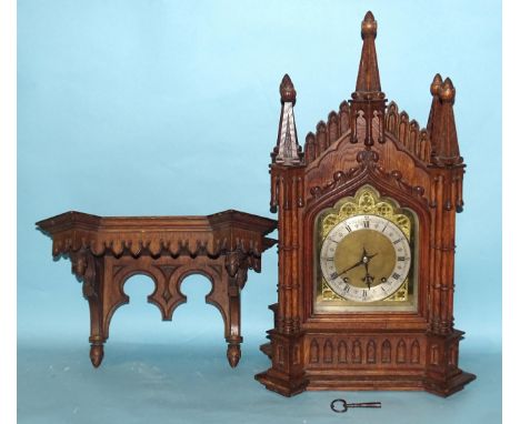 A late-19th/early-20th century oak bracket clock, the architectural Gothic case enclosing a gong-striking movement, the gilt 