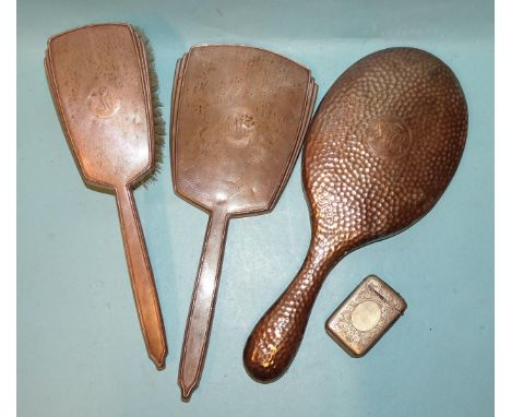 An engine-turned silver-backed hand mirror and clothes brush, (marks rubbed), another silver-backed mirror, London 1905 and a