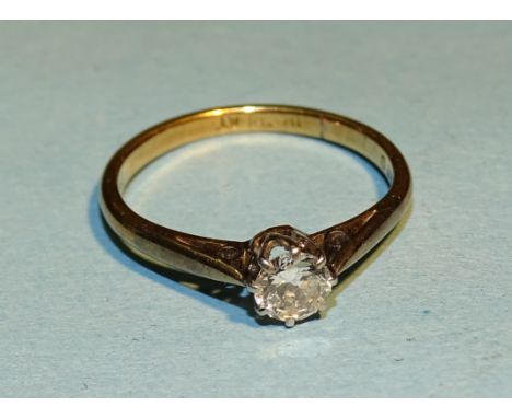 A solitaire diamond ring claw-set a brilliant-cut diamond of approximately 0.25cts, in 18ct yellow gold and platinum mount, s