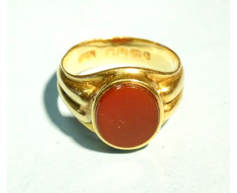 An 18ct yellow gold signet ring with ribbed shank and carnelian intaglio, (plain), size Q, 8.3g. 