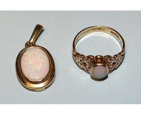 A 9ct gold pendant set opal, a pair of 9ct gold opal earrings and a 9ct gold opal-set ring, size N, total weight 7.5g. 