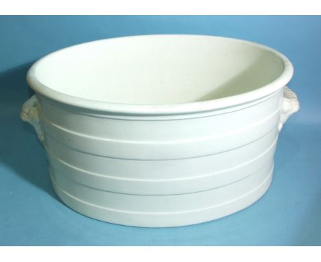 A large 19th century white ceramic foot bath of plain banded oval form, 58cm wide, 26cm high. 