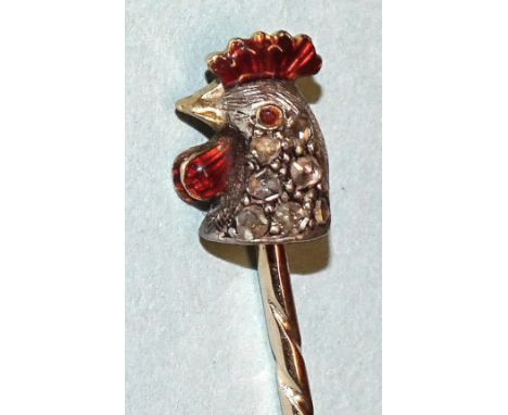 A novelty stick pin in the form of a chicken's head set rose-cut diamonds, with enamelled comb, wattle and eye, tested as 18c