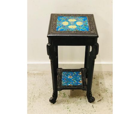 An ebonised pot stand with tiled top and lower shelf.
