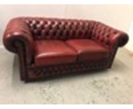 A Chesterfield style Ox Blood two seater sofa