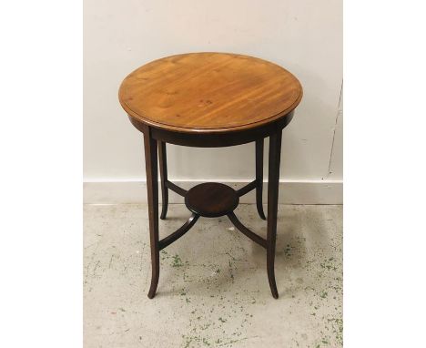 An occasional table with decorative inlay on four fluted legs with a lower galleried shelf H 69cm x 55cm Diameter.