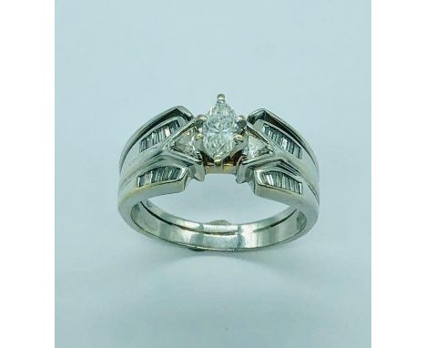 A white gold single stone ring with graduated shoulders.