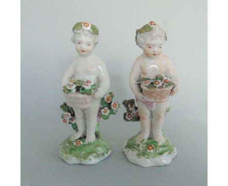 A pair of Derby Porcelain Cherubs holding baskets of flowers Circa 1765 patch marks Size - 11 cm high approx Condition - mino