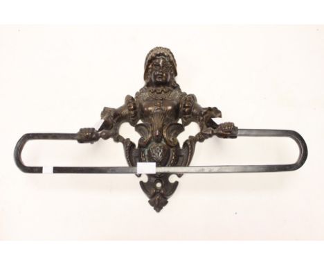 ****Ex Luddington Manor****A cast bronze towel rail, with figure surmount 