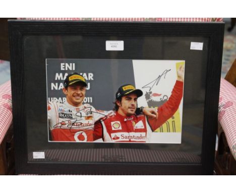 Formula 1 Memorabilia: A framed and signed Fernando Alonso and Jenson Button photograph, complete with COA.