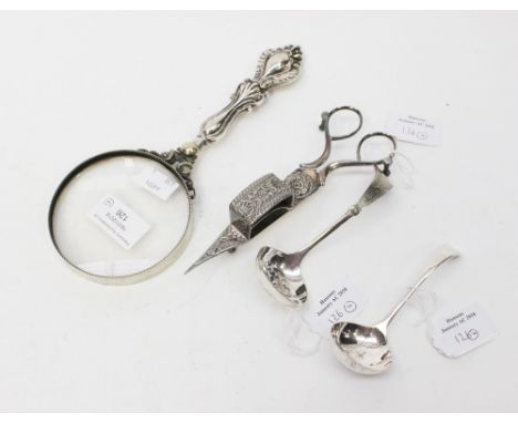 A silver ladle spoon and one plated example, together with a silver handled magnifying glass and white metal candle snuffer (