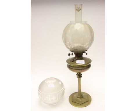  A heavy brass based oil lamp, etched glass globes, funnel, etc 
