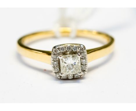 A princess cut diamond ring, with a halo surround of small diamonds, the central diamond weighing approx 0.30ct, finger size 