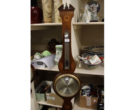 A Josh Testi and Co wheel barometer, incorporating thermometer, the case being oak, having satinwood decoration 