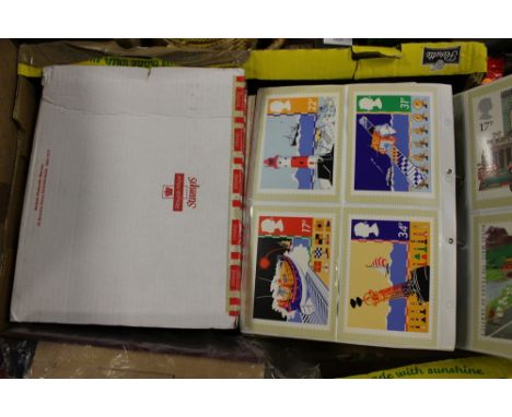 Two boxes containing nine stamp F.D.C. and product card albums