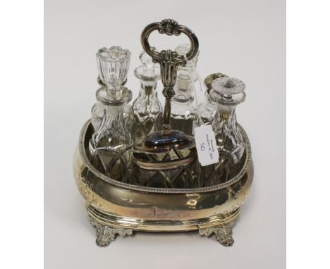 A seven piece cruet set in silver caddy, London hallmark 1842 on the stand, various bottles (10