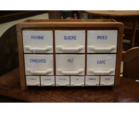 A French kitchen spice and food cupboard, the ceramic drawers fitted in a wooden frame