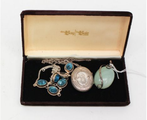 A silver and jade type pendant, oval in shape with a scroll silver surround, a white metal (900) and blue paste necklace comp