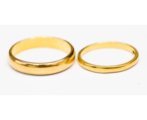 Two 22ct gold plain wedding rings, one 3mm wide, N1/2 , the other 1.5mm wide, size K, with a combined total gross weight of a