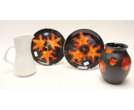 A Poole Pottery Art vase with 'sunspot' pattern, together with a pair of Maple Leaf Art Pottery plates and a 1960's jug, buff