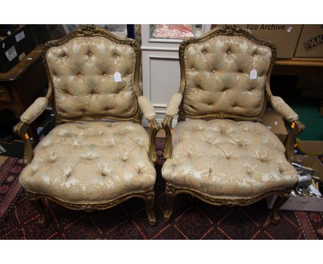 A pair of 19th Century French giltwood fauteuils, button backed