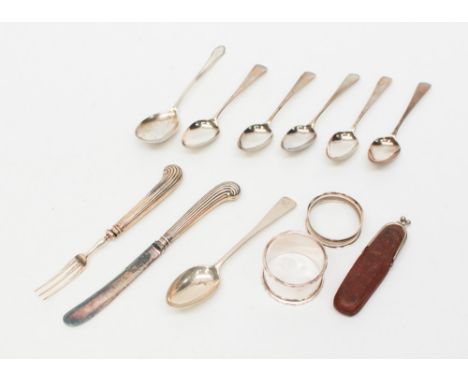 A collection of silver spoons, napkin rings, a mother of pearl pen/multitool penknife (s/s blades), also Georgian and filled 