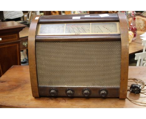 A vintage G.E.C. radio, Cat.No 6638, in wood and bakelite casing