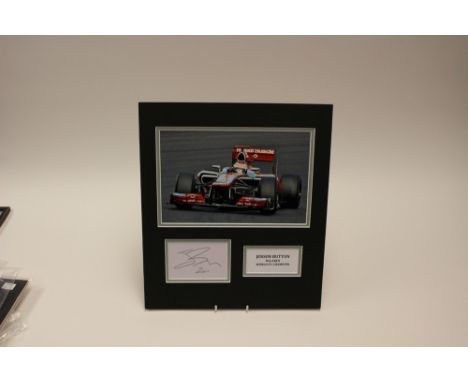 Formula 1 Memorabilia: An action photograph of Jenson Button, complete with signed card, in card backed frame, complete with 