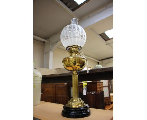 A Victorian brass oil lamp, complete with later shade