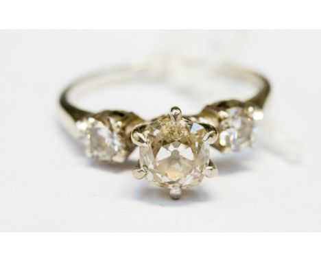 A diamond three stone ring, the centre cushion shaped old cut diamond approx. 1 carat - assessed J/K colour, assessed clarity