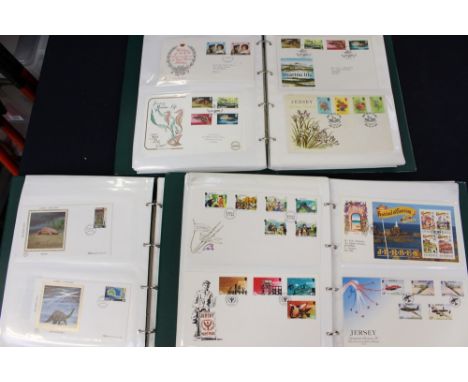 Three stamp albums containing Jersey first day covers & mint stamp packs, including WW2 Jersey covers