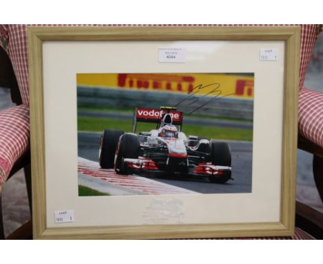 Formula 1 Memorabilia: A signed and framed photograph of Jenson Button, Mercedes-Benz action photograph, signed to upper righ