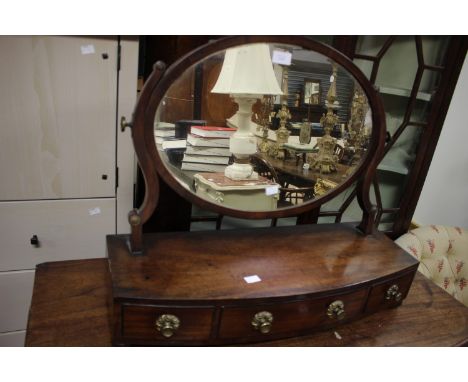 ****Ex Luddington Manor****An early 19th Century bow fronted mahogany toilet mirror, having three drawers to base section, 64