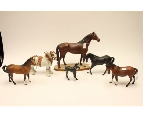 A collection of Beswick horses, including a light grey Shire Horse, a Hunter on wooden base, two matte black horses and two m