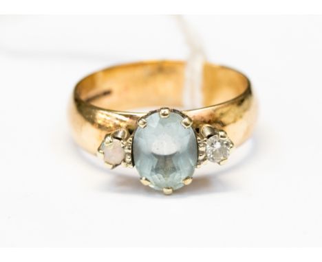  An aquamarine, diamond and opal 9ct yellow gold dress ring, claw set to the centre oval cut aquamarine flanked by small opal