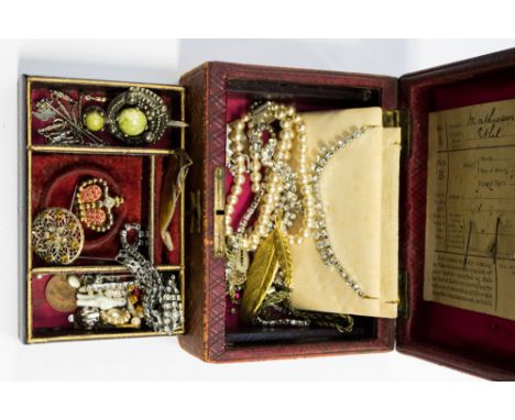 A vintage leather jewel box and contents, paste necklaces, brooches etc