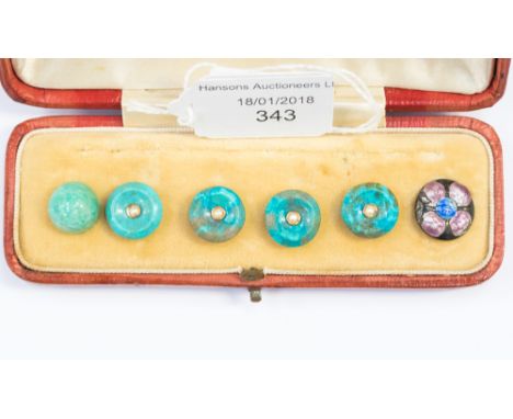 Set of five turquoise buttons each set with a central seed pearl with gold surround, plus one white metal enamel button, boxe