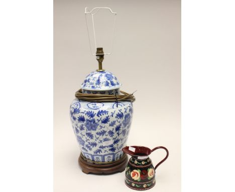 A blue and white Oriental style table lamp with wooden plinth, with a metal barge style hand painted milk jug 