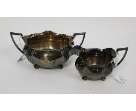 A silver monogrammed, twin handled sucrier, Sheffield 1905 with matching jug, approx weight 17.2ozt (2)