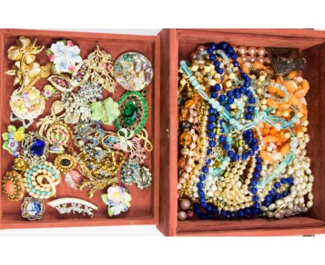 A jewellery box with vintage brooches, necklaces and pendants on lower shelf (pink suedette)