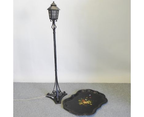 A black painted wrought iron standard lamp, 164cm high, together with a Victorian papier mache tray