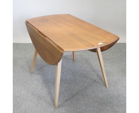 An Ercol light elm drop leaf dining table,