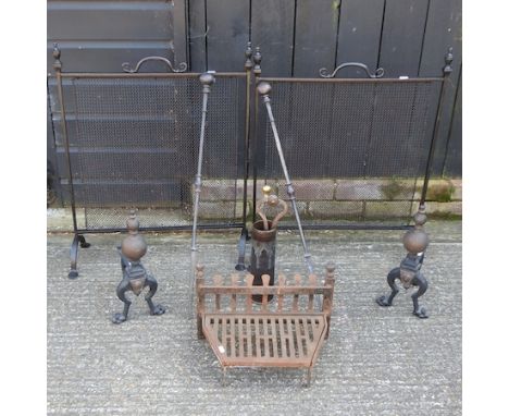 A cast iron fire grate, 40cm, together with a pair of fire dogs, two spark guards, a decorative shell casing and a collection