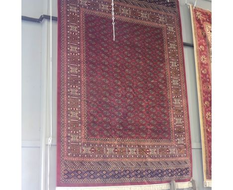 A Bokhara style carpet, with all over medallions on a red ground, 280 x 200cm