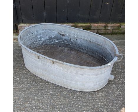 An oval galvanized metal garden trough, 114cm