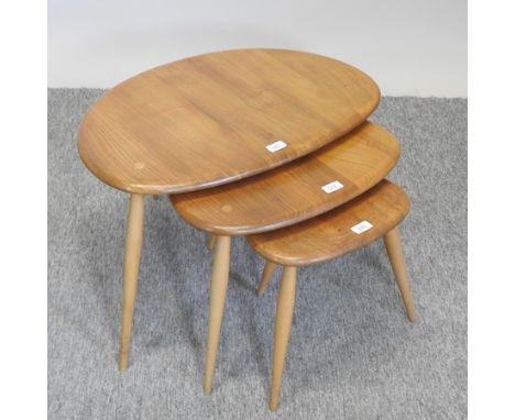 An Ercol light elm nest of three 'pebble' occasional tables