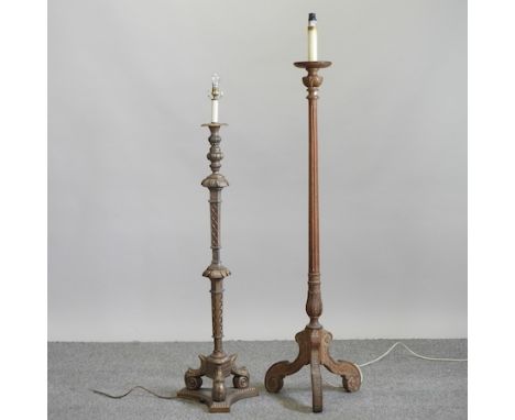 A gold painted standard lamp with foliate decoration, 130cm high, together with a limed oak standard lamp on a tripod base